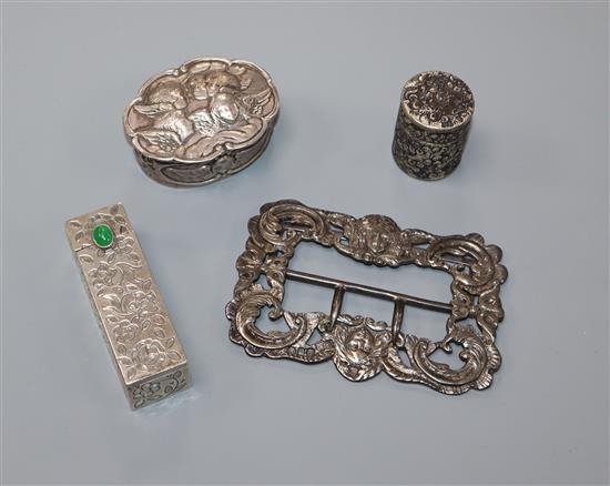 A late Victorian silver buckle, a William Comyns silver pill box, an 800 lipstick holder and a Victorian silver small jar.